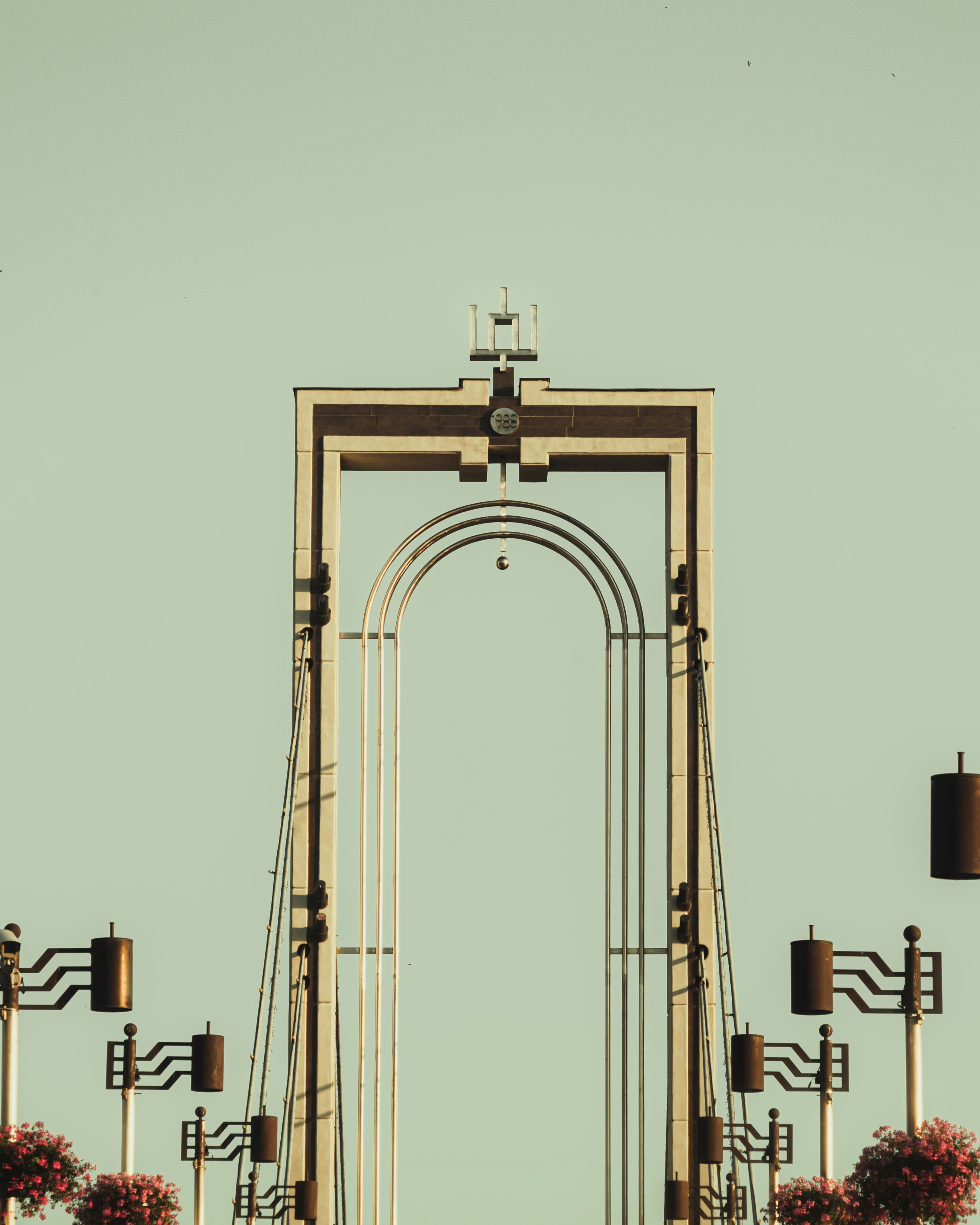 brown concrete arch with bell tower